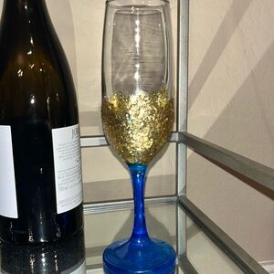 Gold glitter and blue stemmed champagne flute